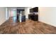 Open-concept space with hardwood floors connecting living area to the modern kitchen at 820 Houston Ct, Haw River, NC 27258