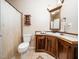 Well-maintained bathroom with wood cabinetry, granite countertop, and updated fixtures at 8917 Thompson Mill Rd, Wake Forest, NC 27587