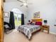 Bright bedroom featuring a large window, wood frame bed, and vaulted ceiling at 8917 Thompson Mill Rd, Wake Forest, NC 27587