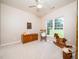 Bright bedroom with large window, ceiling fan, and plush carpet, offering a cozy retreat at 8917 Thompson Mill Rd, Wake Forest, NC 27587