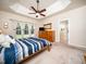 Comfortable bedroom with carpet, windows, and an ensuite bathroom with wooden cabinetry at 8917 Thompson Mill Rd, Wake Forest, NC 27587