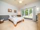 Cozy bedroom with a large window, neutral walls, and comfortable furnishings at 8917 Thompson Mill Rd, Wake Forest, NC 27587