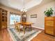 Elegant dining room with a chandelier, cabinet, and large window, perfect for Gathering gatherings at 8917 Thompson Mill Rd, Wake Forest, NC 27587