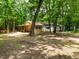 Exterior of home featuring a covered porch and surrounded by mature trees and a natural landscape at 8917 Thompson Mill Rd, Wake Forest, NC 27587