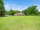 Exterior shot of a well-kept home with a lush green lawn, showcasing its serene and inviting curb appeal at 8917 Thompson Mill Rd, Wake Forest, NC 27587