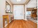 Inviting foyer featuring hardwood floors, a decorative mirror, and an open view into the dining area at 8917 Thompson Mill Rd, Wake Forest, NC 27587