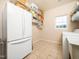 Functional laundry room with appliances, shelving, and ample storage space at 8917 Thompson Mill Rd, Wake Forest, NC 27587