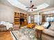 Open living space with hardwood floors, a tray ceiling, and a built-in entertainment center at 8917 Thompson Mill Rd, Wake Forest, NC 27587