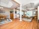Spacious living room with hardwood floors, large windows, and a seamless flow into the kitchen area at 8917 Thompson Mill Rd, Wake Forest, NC 27587