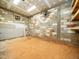 Unfinished room featuring block walls, concrete floor, and a ventilation fan with a wall-mounted shelf at 8917 Thompson Mill Rd, Wake Forest, NC 27587