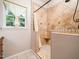 An updated shower with decorative tile, window and shampoo nook at 8917 Thompson Mill Rd, Wake Forest, NC 27587