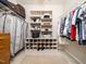 Spacious walk-in closet features shelving, shoe racks, and rods for hanging clothes at 8917 Thompson Mill Rd, Wake Forest, NC 27587
