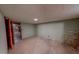 This unfinished basement bedroom has painted walls and tile floors at 9455 Boston Rd, Roxboro, NC 27574