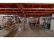 This basement features exposed beams and pipes, a pool table, and storage at 9455 Boston Rd, Roxboro, NC 27574
