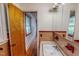 Bathroom with a sink and a mirror, and a view down the hallway at 9455 Boston Rd, Roxboro, NC 27574