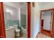 The bathroom has green tiling, a sink, toilet, and a bathtub-shower combo at 9455 Boston Rd, Roxboro, NC 27574