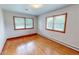 Sunlit bedroom with beautiful hardwood floors and bright walls at 9455 Boston Rd, Roxboro, NC 27574