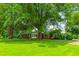 Ranch style home with large trees providing shade in a beautiful lawn with mature trees at 9455 Boston Rd, Roxboro, NC 27574