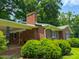 A charming brick house with green shutters and lush landscaping at 9455 Boston Rd, Roxboro, NC 27574