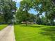 Beautiful property featuring a long driveway, lush green lawn, and a well-maintained home at 9455 Boston Rd, Roxboro, NC 27574