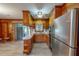 Functional kitchen features stainless steel appliances, wood cabinets, and laminate flooring at 9455 Boston Rd, Roxboro, NC 27574