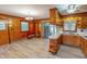 Spacious kitchen with wood cabinetry, ample counter space, eat-in area, and modern flooring at 9455 Boston Rd, Roxboro, NC 27574