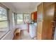 Bright laundry room with a washer, dryer, plenty of natural light, and storage cabinets at 9455 Boston Rd, Roxboro, NC 27574
