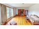 Bright living room with hardwood floors, large windows, elegant sofa and decorative accents at 9455 Boston Rd, Roxboro, NC 27574