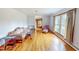 Cozy living room with hardwood floors, comfortable seating, and bright natural light from large windows at 9455 Boston Rd, Roxboro, NC 27574