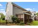 Backyard showcasing a screened porch surrounded by lush landscaping and a cozy garden at 958 Bay Bouquet Ln, Apex, NC 27523