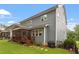 Back of house view with spacious lawn, screened porch, and elegant gray siding at 958 Bay Bouquet Ln, Apex, NC 27523
