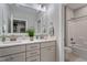 Bright bathroom with double vanity sinks, granite countertops, and tiled shower at 958 Bay Bouquet Ln, Apex, NC 27523