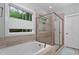 A relaxing bathroom with a soaking tub and a separate glass shower at 958 Bay Bouquet Ln, Apex, NC 27523