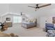 A large bonus room features two ceiling fans, sitting area, piano, and neutral color palette at 958 Bay Bouquet Ln, Apex, NC 27523
