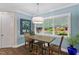 Charming dining nook with table for four, large window with view and modern drum-style lighting fixture at 958 Bay Bouquet Ln, Apex, NC 27523