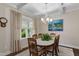 Bright dining room with natural light, coffered ceilings, and a decorative chandelier at 958 Bay Bouquet Ln, Apex, NC 27523