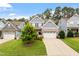 Charming two-story home featuring a well-manicured lawn, stone accents, and a two-car garage at 958 Bay Bouquet Ln, Apex, NC 27523