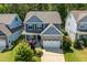 Charming two-story home with stone accents, manicured lawn, and a two-car garage at 958 Bay Bouquet Ln, Apex, NC 27523