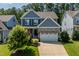 Two-story home with stone accents, attached garage, and manicured lawn in a desirable neighborhood at 958 Bay Bouquet Ln, Apex, NC 27523