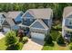 Two-story home with blue siding, stone accents, and beautifully landscaped front yard in a residential area at 958 Bay Bouquet Ln, Apex, NC 27523
