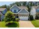 Charming two-story home with a manicured front yard and two-car garage at 958 Bay Bouquet Ln, Apex, NC 27523