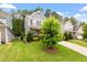 Well-maintained front yard with lush green grass and mature landscaping surrounding a charming home at 958 Bay Bouquet Ln, Apex, NC 27523