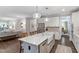 Open-concept kitchen with island, farmhouse sink, stainless appliances, granite countertops, and seamless flow to living spaces at 958 Bay Bouquet Ln, Apex, NC 27523