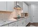 Bright kitchen features white cabinets, granite countertops, subway tile backsplash, and stainless steel appliances at 958 Bay Bouquet Ln, Apex, NC 27523