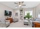 Comfortable living area with neutral tones, ample seating, a ceiling fan, and a window with natural light at 958 Bay Bouquet Ln, Apex, NC 27523
