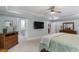 This main bedroom features a ceiling fan, TV, and ensuite bathroom at 958 Bay Bouquet Ln, Apex, NC 27523