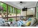 Relaxing screened porch with comfortable seating, a ceiling fan, and scenic views of the backyard at 958 Bay Bouquet Ln, Apex, NC 27523