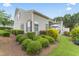 Backyard featuring lush green landscaping, a patio, and a well-maintained lawn at 100 Beaconwood Ln, Holly Springs, NC 27540