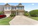 Attractive townhome with well-maintained landscaping, a private driveway, and an attached garage at 100 Beaconwood Ln, Holly Springs, NC 27540