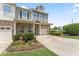 Charming two-story home with well-maintained landscaping, a front porch, and a driveway at 100 Beaconwood Ln, Holly Springs, NC 27540